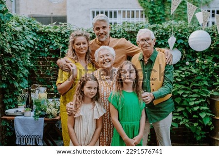 Multi-generation family on outdoor summer garden party, celebrating birthday Royalty-Free Stock Photo #2291576741