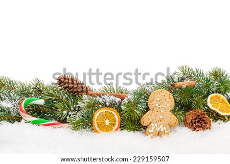 Christmas food and decor over snow fir tree. Isolated on white background with copy space