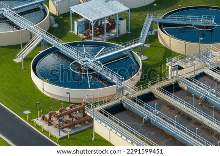 Aerial view of modern water cleaning facility at urban wastewater treatment plant. Purification process of removing undesirable chemicals, suspended solids and gases from contaminated liquid Royalty-Free Stock Photo #2291599451