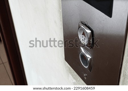 Elevator buttons on an apartment wall
