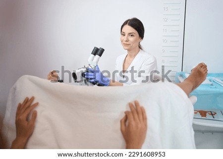 Woman gynecologist doing an examination of the patient uterus
