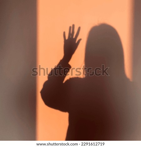 dark figure on a wall, transparent girl, young person, evening sun light, morning silhuette of woman, cozy aesthatic photo