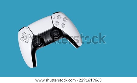 White gamepad on a blue background. Game controller for video games Royalty-Free Stock Photo #2291619663