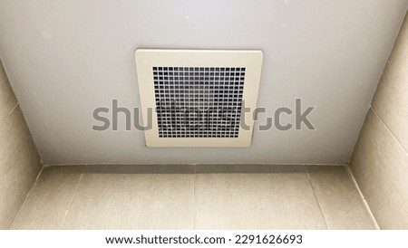 Exhaust fan on the top of ceiling in the bathroom