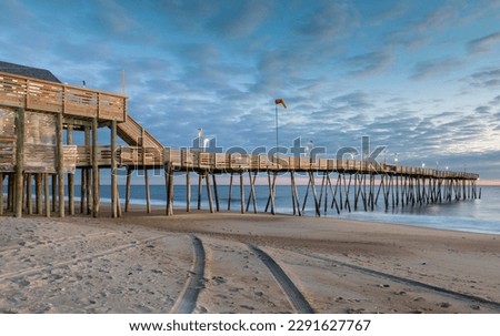 Fishing avalon pier over the Atlantic ocean, closed for the winter season, in the Outer Banks of North Carolina. Royalty-Free Stock Photo #2291627767