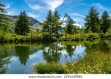 Matterhorn overlooks the Swiss town of Zermatt, in the canton of Valais. Royalty-Free Stock Photo #2291630985