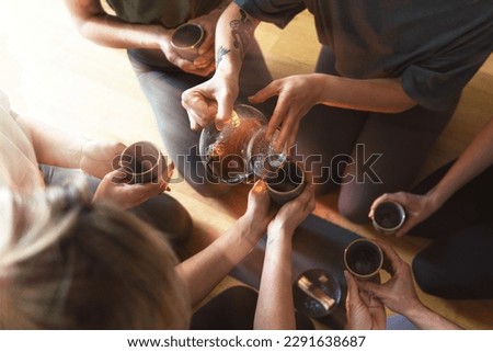 Young woman is pouring hot tea to her friends sitting around a tray during a tea ceremony. Royalty-Free Stock Photo #2291638687