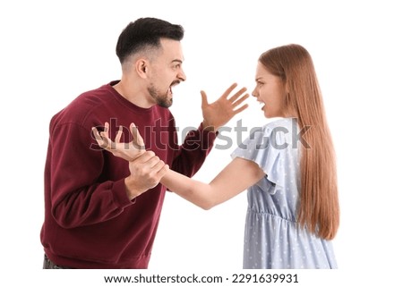 Angry young couple shouting on white background. Domestic violence concept Royalty-Free Stock Photo #2291639931