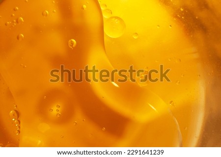 Gold Oil bubbles close up. circles of orange water macro. abstract shiny yellow background. Royalty-Free Stock Photo #2291641239