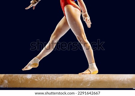 legs female gymnast step on balance beam in gymnastics on black background, sports summer games