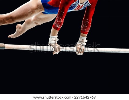 close-up female gymnast exercise on uneven bars in artistic gymnastics, black background, sports summer games Royalty-Free Stock Photo #2291642769