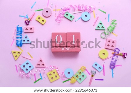 Cube calendar with date 01 JUNE, baby blocks and confetti on pink background. Children's Day celebration