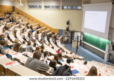 Defocused image of audience at the conference hall. Conference and Presentation. Business and Entrepreneurship. Faculty lecture and workshop. Audience in the lecture hall. Participants making notes. Royalty-Free Stock Photo #2291648325
