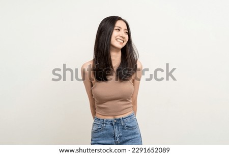 Beautiful smiling happy young asian woman age around 25 in brown shirt. Charming female lady standing pose on isolated white background. Asian cute people looking camera confident with white backdrop.