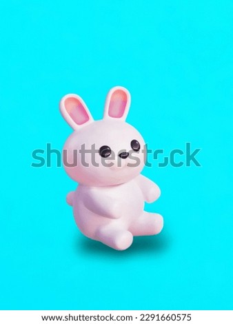 Rubber toy rabbit on a blue background