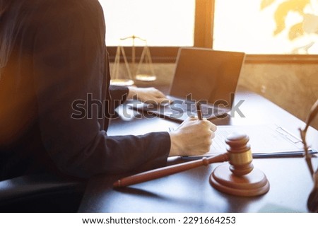 Lawyer holding contract documents in hand and preparing to sign a consulting contract for a team of business people who need legal advice to run their business in accordance with the law