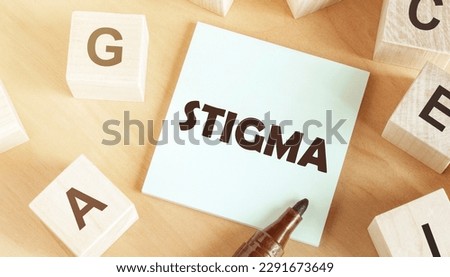 Sticker with text Stigma in the middle of wooden cubes with letters