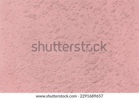 Close-up of Colorful pink Plastered Uneven Stucco Wall. Abstract Texture. Trendy background, copy space