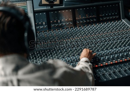 Sound engineer used digital audio mixer Sliders Engineer presses key Control panel Recording studio technician