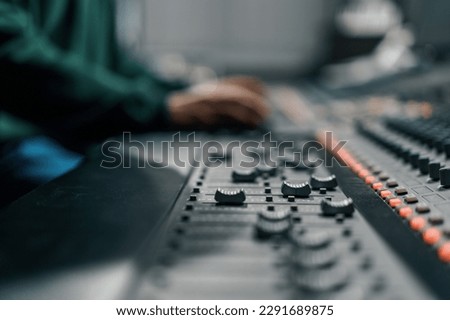 Sound engineer used digital audio mixer Sliders Engineer presses key Control panel Recording studio technician Royalty-Free Stock Photo #2291689875