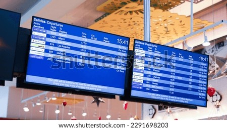 airport monitor displaying the status and destinations of business flights represents the fast-paced world of commerce and global connectivity. It signifies the importance of efficient communication  Royalty-Free Stock Photo #2291698203
