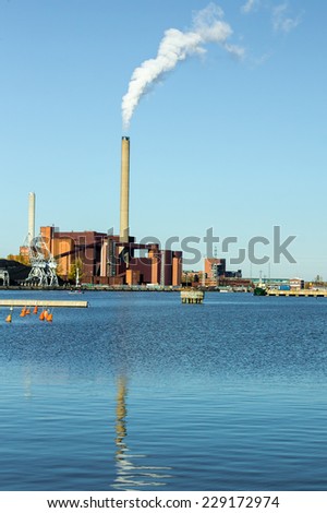 Smoke coming from a coal plant on the ocean shore