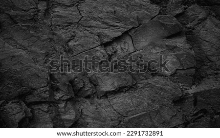 Black white rock texture. Dark gray stone granite background for design. Cracked rough mountain surface. Close-up. Crushed broken. Royalty-Free Stock Photo #2291732891