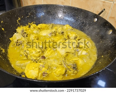 Pictures of chicken rendang, a dish of chicken cooked slowly in coconut milk and various spices until fairly dry. A must have dish during Eid Mubarak morning. 