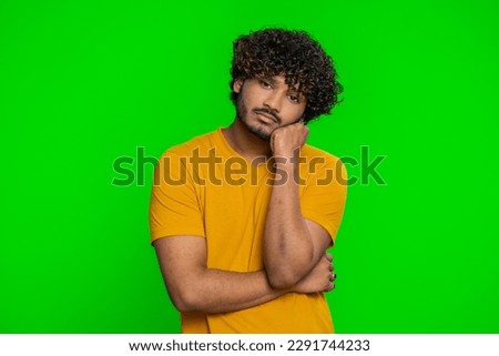 Tired bored young indian man indifferent expression, exhausted of tedious story, not interested in communication talk, displeasure, uninteresting. Hindu guy isolated on green chroma key background Royalty-Free Stock Photo #2291744233