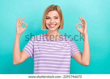 Portrait of cute positive girl straight hairstyle dressed stylish t-shirt showing okey nice work isolated on turquoise color background