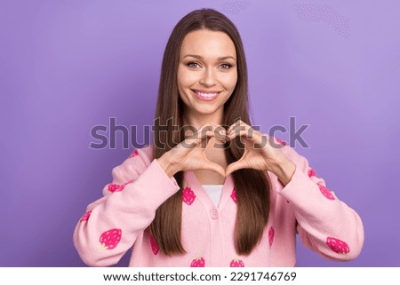 Photo of cute shiny girl wear berry print cardigan smiling showing arms heart isolated violet color background