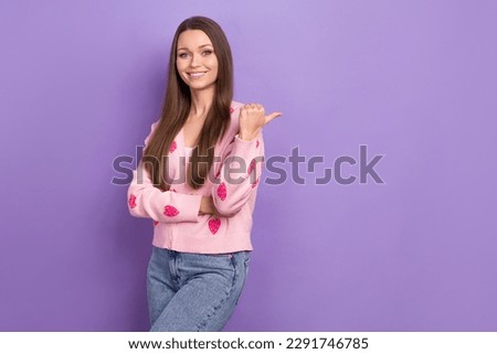 Photo of shiny cute lady dressed strawberry print cardigan showing thumb back empty space isolated purple color background
