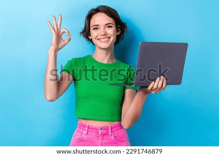 Photo of shiny confident lady dressed green top showing okey texting modern gadget isolated blue color background