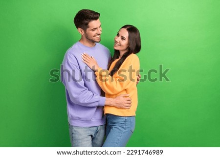Photo of two peaceful cheerful partners hugging look each other toothy smile isolated on green color background Royalty-Free Stock Photo #2291746989