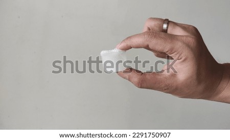 cube ice hold by hand on the white background