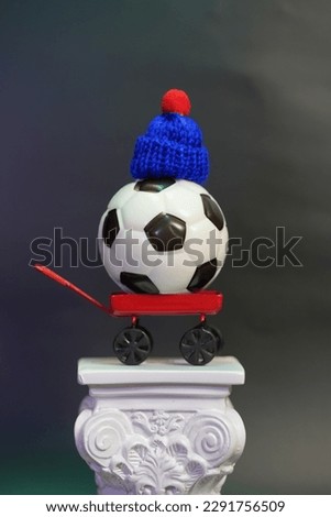 miniature soccer ball perched on a column macro photography