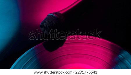 musical abstract background with vinyl record and microphone Royalty-Free Stock Photo #2291775541