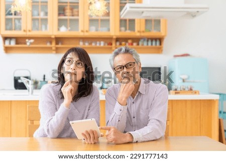 asian senior age couple using a tablet computer, trouble Royalty-Free Stock Photo #2291777143