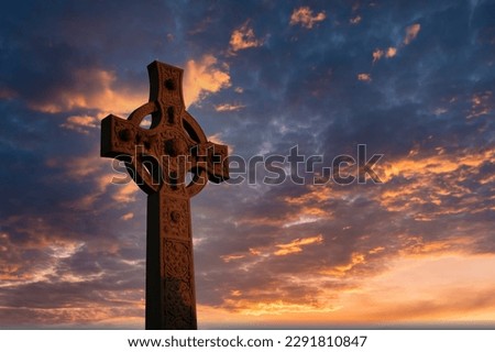Christian cross on hill outdoors at sunrise. Resurrection of Jesus. Concept photo. Selective focus.