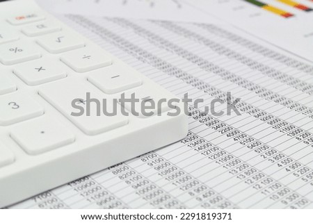 Close up of calculator on financial papers.