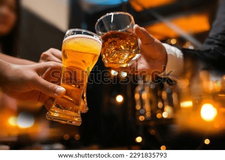 food and drink male friends are happy drinking beer and clinking glasses at a bar or pub. Royalty-Free Stock Photo #2291835793