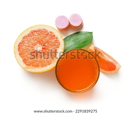 Glass of vitamin C effervescent tablet dissolved in water and grapefruit isolated on white background