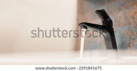 Water tap , faucet. Flow water in bathroom with sink. Modern clean hause. Hygiene concept.