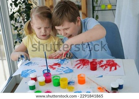 Children paint fingers drawing baby painting hand therapy children art play. Kids have fun and create picture. Palms of different colors. Sensory development and experiences