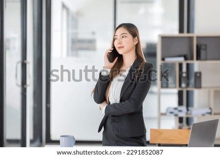 Young business Asian woman holding document file and Call phone stand in workplace office, Stack of business overload paper.