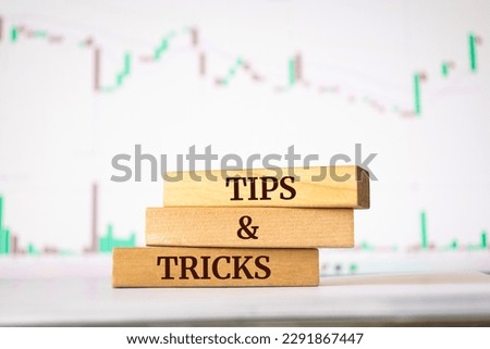 Wooden blocks with words 'tips and tricks'. Business concept