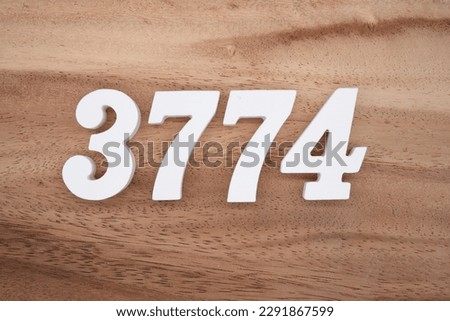 White number 3774 on a brown and light brown wooden background.