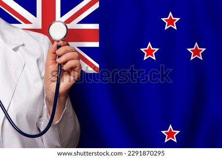 New Zealand doctor's hand with stethoscope on the background of flag of New Zealand Medicine, clinic, practitioner, healthcare