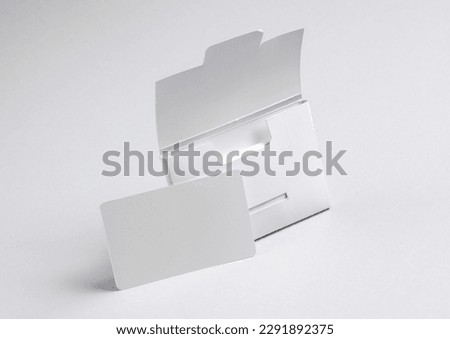 Packing box with empty white bank card on a gray background. Template for design Royalty-Free Stock Photo #2291892375