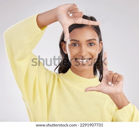 Finger frame, portrait and happy woman in white background, studio or review profile picture. Face, indian female and hands of model, border perspective and selfie of creativity, smile or photography